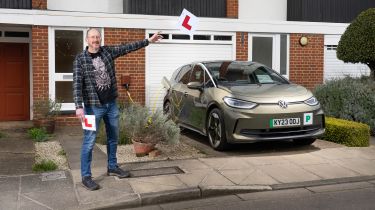 Auto Express chief sub-editor Andy Pringle holding two L-plates while standing next to the Volkswagen ID.3